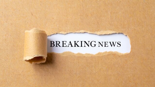 The words Breaking News standing on a white background, ripped paper.