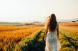 © Evgenii Starkov - Woman Walking in Wheat Field