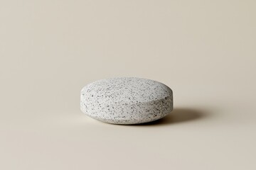 Poster - A minimalist studio shot featuring a round, speckled concrete plinth against a plain beige background, ideal for showcasing product photography and design concepts.