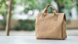 © Parsudi - Beige Brown Patterned Tote Bag On Light Gray Table