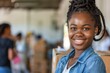 © Baba Images - Young african american female volunteer at community center