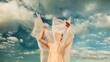 © ADDICTIVE STOCK - Woman with flowing fabric in the wind against cloudy sky
