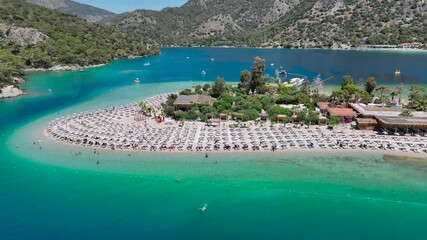 Wall Mural - Aerial view of Oludeniz Beach with greenery, boats, beachgoers, turquoise ocean and green mountains