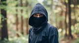 Mysterious hooded ninja in forest setting
