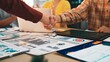 © InfiniteFlow - A diverse business team celebrates a successful partnership with a handshake over various financial reports and data analytics in a bright modern office environment. SACTR