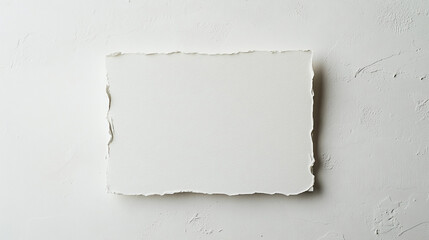 Poster - A white torn paper sheet on a textured white surface creating a minimalist and clean presentation space