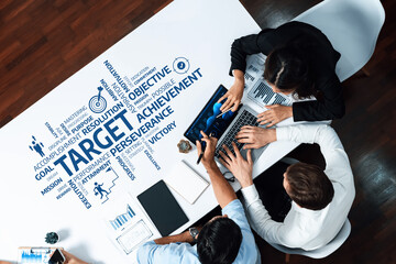 Aufkleber - A high-angle view of a diverse business team engaged in a dynamic meeting, focusing on data analysis and strategic planning to achieve targets and foster collaboration. Amity