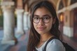 © NikoG - Portrait of a young Hispanic female student on college campus