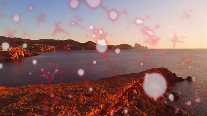 Poster - animating red molecular structures over coastal landscape during sunset scene