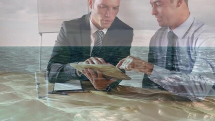Poster - Discussing business, businessmen using tablet with ocean waves animation overlay