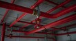 © Cintia - A network of bright red sprinkler pipes and sprinkler heads are installed on the ceiling, ensuring safety against potential fire hazards.