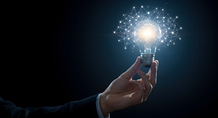 Poster - Hand Holding Glowing Lightbulb with Sparkling Particles Against a Dark Background Represents Innovation