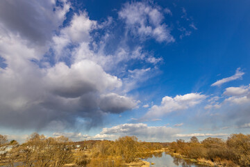 Wall Mural - the sky is cloudy and the sun is shining through the clouds