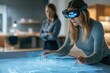 © Isuru - A woman wearing AR glasses interacts with a holographic 3D building model on a smart table.
