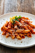 © Jacek Chabraszewski - Penne noodles with tomato sauce and parmesan cheese served on wooden table