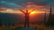 © achmad - Man with arms raised at sunset mountaintop vista