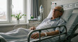 © Vasiliy - Senior man in hospital bed looking thoughtfully at window. Patient recovery and elderly healthcare concept for medical treatment programs
