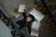 © olja - A woman in black reaches for falling sheet music on a staircase, captured from an overhead perspective.