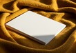 © Md - White book mockup on mustard yellow blanket for product presentation