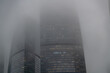© Андрей Рыков - Skyscraper enveloped in fog creates a mysterious urban landscape