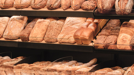 Poster - Breads on the shelf in the market or bakery.  bakery with many different types of bread on display. bread is arranged in rows and there are many different types of bread to choose from.