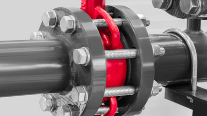 Aufkleber - A red and silver pipe with a red cap is attached to a silver pipe. The red cap is secured with several bolts and nuts