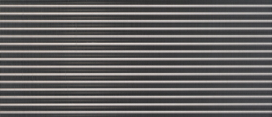 Fototapete - Close-up of a black metal surface with many small lines as a metallic industrial texture background. The lines are very close to each other and the surface is very shiny