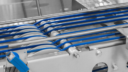 Aufkleber - A conveyor belt with blue and silver stripes. The belt is moving and the image is in black and white