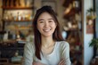 © Baba Images - Portrait of a smiling young Asian woman small business owner