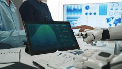 Poster - a modern business meeting showcasing data analysis on a tablet, featuring a robotic hand and engaged