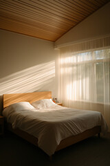 Poster - Sunlight streaming through a cozy bedroom with warm wooden accents and soft linens