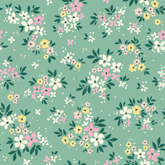 Cute floral background. Easter spring Floral pattern with small yellow, pink and white flowers on green gray background. Seamless pattern for design and fashion prints. Ditsy style. Stock vector 
