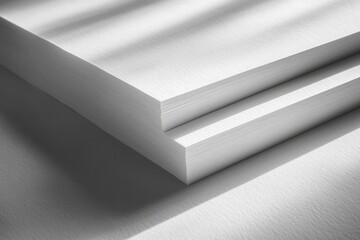 Aufkleber - Stacked white sheets of paper illuminated by natural light streaming through window shadows in a serene workspace