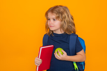 Fototapete - Studio portrait of school child. Schoolboy with book isolated on yellow background. Elementary school kids. Pupil go study. Clever schoolboy learning. Kids study, knowledge and education concept.