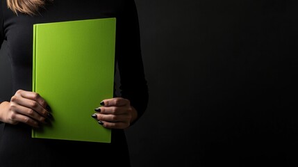 Poster - Woman in office attire holding green folder with important documents while standing at her desk in a modern workspace