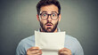 © Rat - Surprised man reading shocking news office space portrait indoor eye-level human emotion