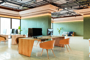 Poster - Modern open-plan office interior with wooden desks, green walls, and contemporary furniture in a clean architectural business setting. 3D Rendering