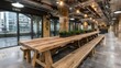© A4719 - Long rustic wooden table with benches in a modern industrial interior, featuring exposed pipes and polished concrete floor.