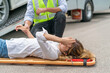 © tai - agent help injured woman using stretcher from car accident in asia countryside. asian woman in pain lifting by stretcher. unconscious woman lying got rescue from emergency officer from vehicle crash
