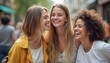 © natakot - This lively image captures three diverse young women, each radiating happiness as they share a moment of joy in a bustling city street. Their genuine smiles and playful expressions create an