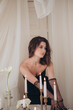 © Владимир Паляница - Woman in black dress posing near the table with candles