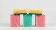 © Tika - Colorful Sponges Stacked on White Surface Cleaning and Household Concept