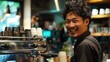 © Morning - Bearded barista smiles while making coffee at a cafe.