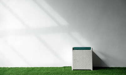 Poster - Grey concrete wall texture with light, shadow and chair garden on green grass turf field,Architecture exterior modern house wall with sunlight reflection  from window on white wall surface background