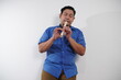 © airdone - Asian man playing recorder flute, musical instrument