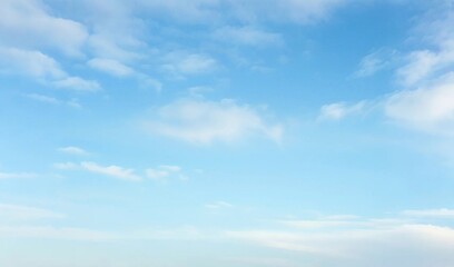 light blue vault of heaven, filmy clouds wandering. the light blue sky is pure and vast. a few filmy