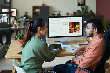 Aufkleber - Side view of young intercultural designers using and discussing possibilities of new AI image generator in front of computer screen