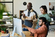 © pressmaster - Group of young colleagues looking at screen of desktop computer while one of them pointing at new software product