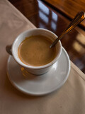Enjoying a creamy coffee Lungo in a prague cafe during springtime