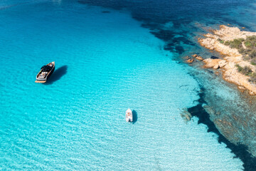 Wall Mural - aerial view of beautiful luxury yacht and boat in blue sea in summer. sardinia, italy. top drone vie